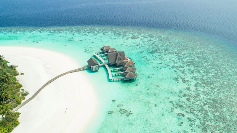 Overwater villas above a turquoise reef